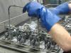 Ultrasonically cleaning carburetors as part of rebuilding
